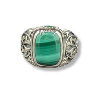Silver ring with a green stone on a white background