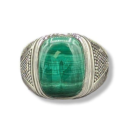 Ring with a green gemstone and silver band on a white background