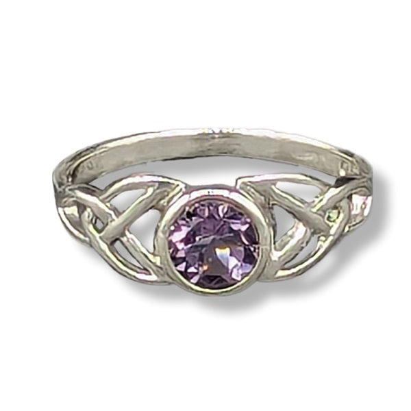 Silver ring with a purple gemstone on a white background
