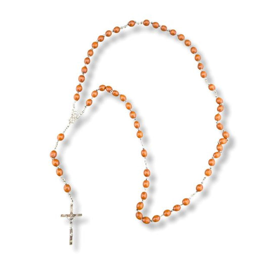 Wooden rosary with a cross on a white background