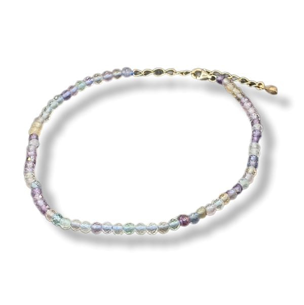 Multicolored beaded anklet on a white background