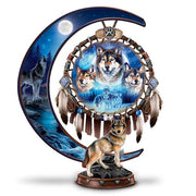 Decorative piece with wolves and a dreamcatcher design on a crescent moon shape on white background