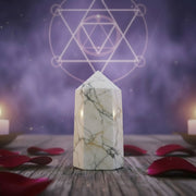 Howlite tower in a spirit setting surrounded by rose petals and candles