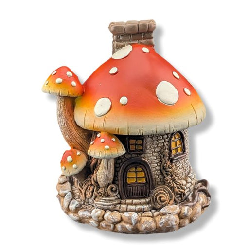 Fairy house with a mushroom-shaped roof on a white background