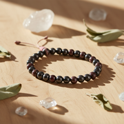 Beaded bracelet on a wooden surface with crystals and leaves