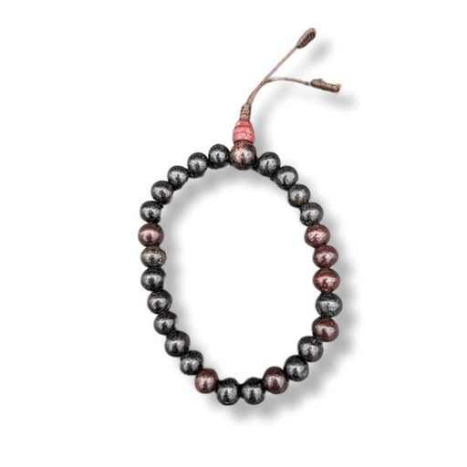 Black wooden wrist mala  bracelet on a white background