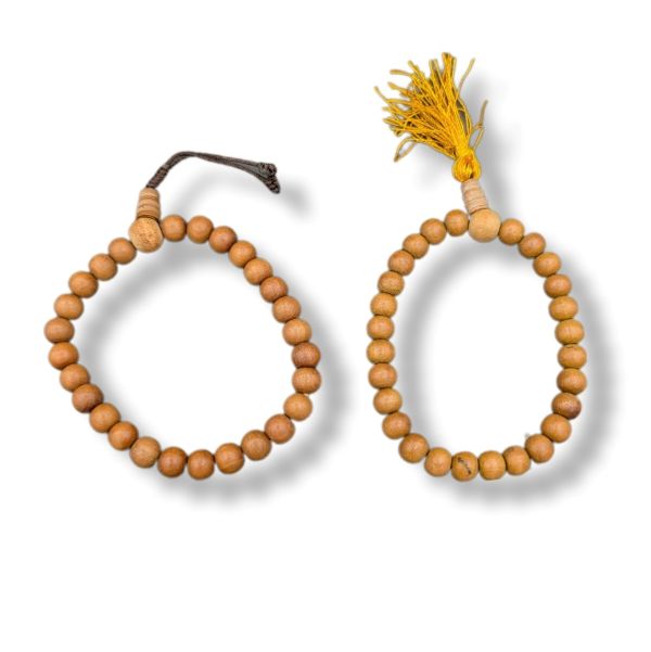 Wooden beaded bracelets with tassels on a white background