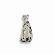 Teardrop-shaped pendant with black and white pattern on a white background