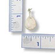 Teardrop-shaped stone pendant with silver bail on a white background with rulers for scale.
