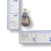 Pendant with a teardrop-shaped stone on a white background with a ruler for scale.