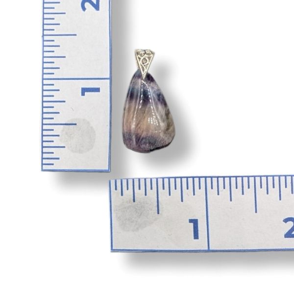 Pendant with a teardrop-shaped stone on a white background with a ruler for scale.