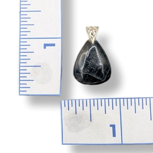 Dark Purple teardrop pendant with gold accent next to a ruler on a white background