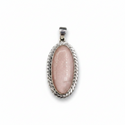 Pink stone pendant with silver frame on a white background