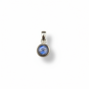 Silver pendant with a blue gemstone on a white background