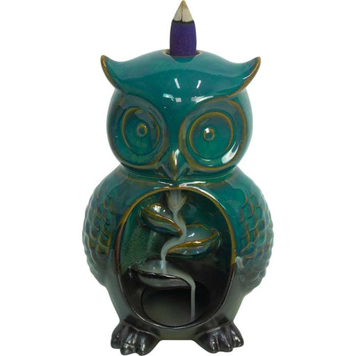 Teal owl-shaped incense burner with a purple cone on a white background