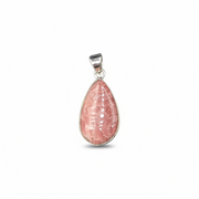 Pink teardrop pendant with silver setting on a white background