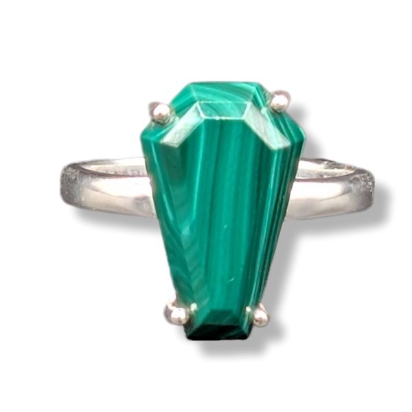 Ring with a green gemstone and silver band on a white background