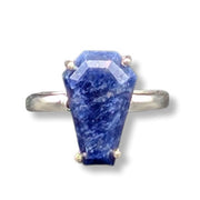 Ring with a large blue stone on a white background