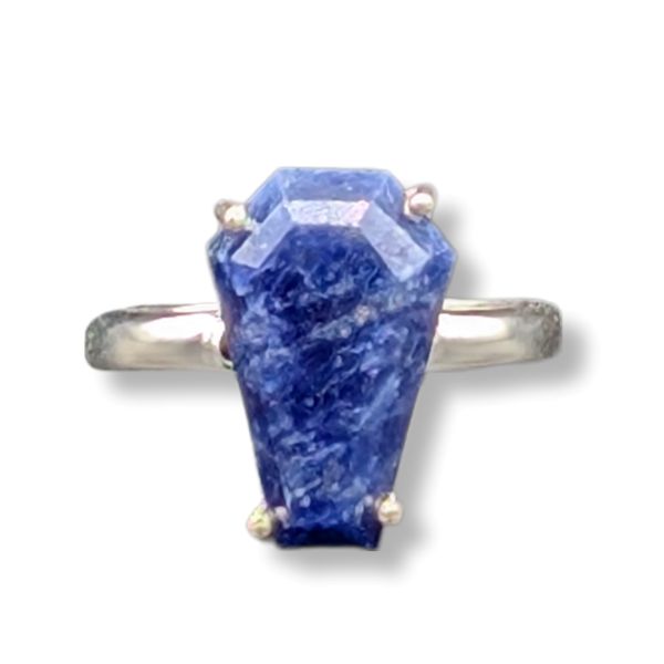 Ring with a large blue stone on a white background