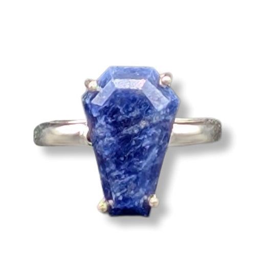 Ring with a large blue stone on a white background