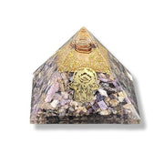 Orgonite pyramid with Charoite and Hamsa Hand on a white background