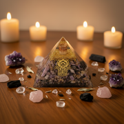 Orgonite pyramid with Charoite and Hamsa Hand on a wooden surface with candles in the background