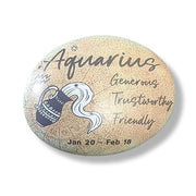 Round stone with Aquarius zodiac design and text on a white background
