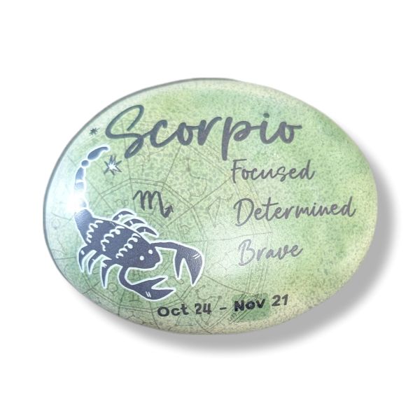 Round stone with Scorpio zodiac design on a white background