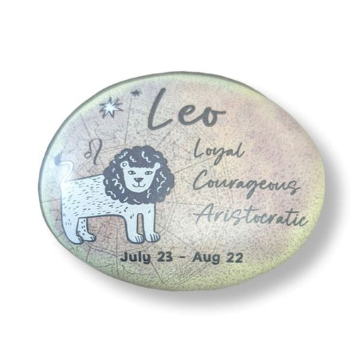 Round stone with Leo zodiac design, lion illustration, and descriptive text on a light background
