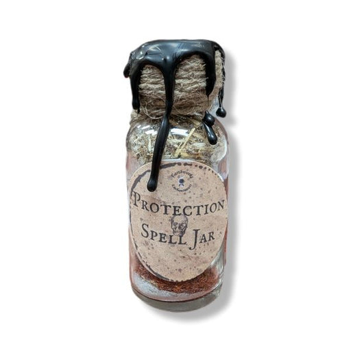 Small glass jar labeled 'Protection Spell Jar' with a black wax on a white background