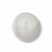 A selenite sphere on a white background