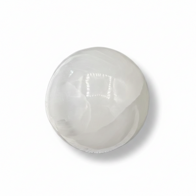 A selenite sphere on a white background
