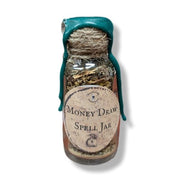 Spell jar labeled 'Money Draw' with a green lid on a white background