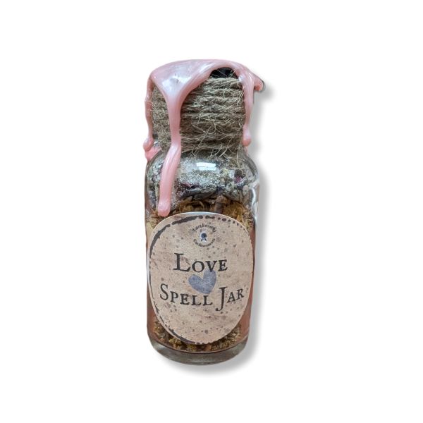 Small glass jar labeled 'Love Spell Jar' with a pink wax on a white background
