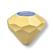 Gold-colored product with a blue label on a white background