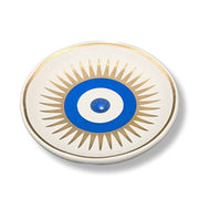 Decorative plate with blue center and gold sunburst pattern on a white background