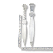 Two decorative selenite knives with a ruler for scale on a white background