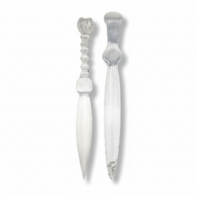 Two selenite knives with decorative handles, shown side by side on a plain white background.