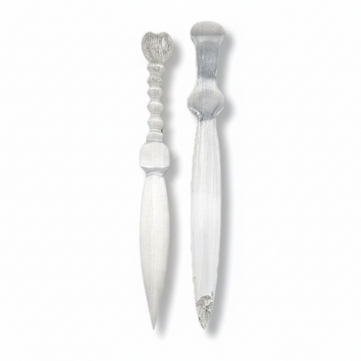 Two selenite knives with decorative handles, shown side by side on a plain white background.