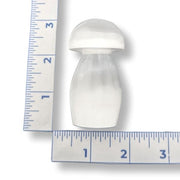 Selenite mushroom-shaped object next to a ruler on a white background