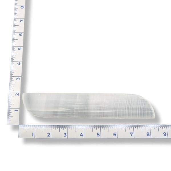 Selenite slab with a ruler for scale on a white background