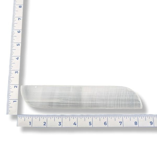 Selenite slab with a ruler for scale on a white background