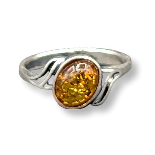 Silver ring with a amber stone on a white background