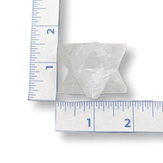 Selenite Merkaba on a white background with a ruler for scale