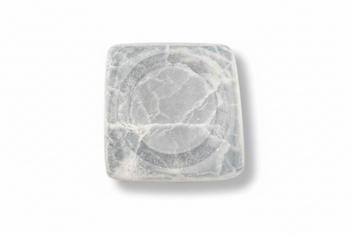 A square white selenite tray with rounded corners and a circular recessed design in the center, featuring natural gray veining, shown on a plain white background.