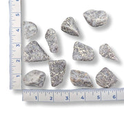 Violet Quartz  with a ruler for scale on a white background