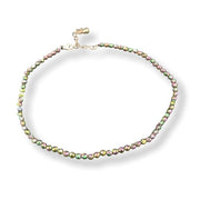 Anklet with multicolored beads on a white background