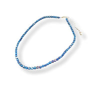 Blue beaded necklace on a white background