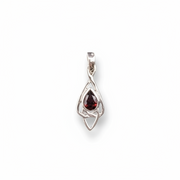 Silver pendant with a red gemstone on a white background