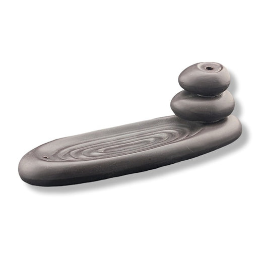Black ceramic backflow incense burner on a white background